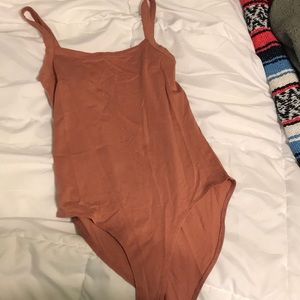 Brand new, pink bodysuit.